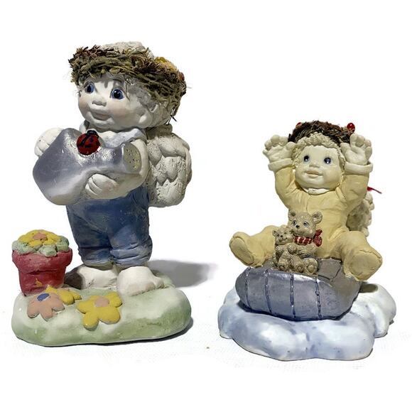 Dreamsicles Figurines Set of 2 Cherub on Sleigh and Cherub Watering Flowers - Picture 1 of 7